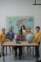 Children learning geography in an elementary classroom with a globe and world map.